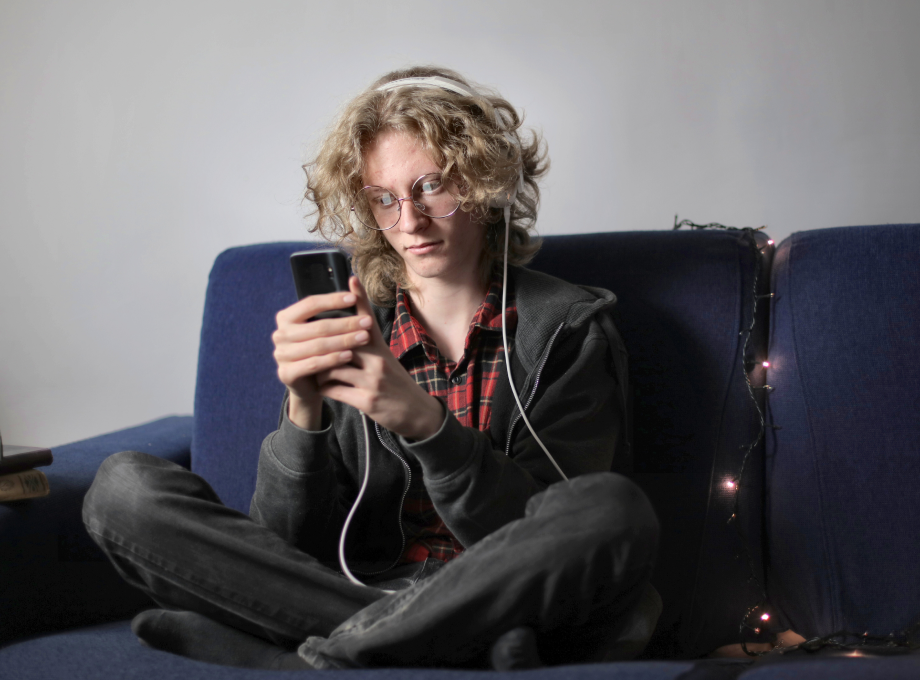  A Young man sending a text message from his home
